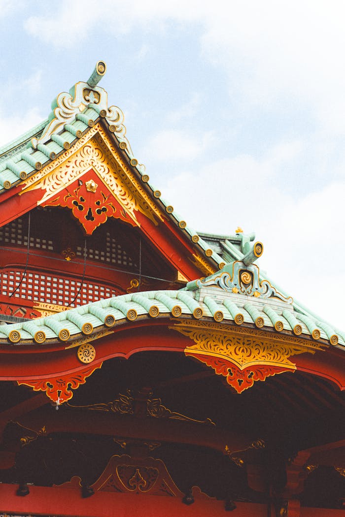 Ornate temple roof with intricate design in Tokyo, Japan, showcasing traditional architecture and vibrant colors.