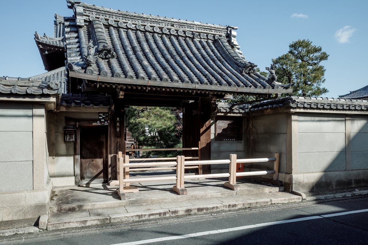 A traditional Japanese temple gate with wooden structure and tiled roof in Kyoto, Japan.