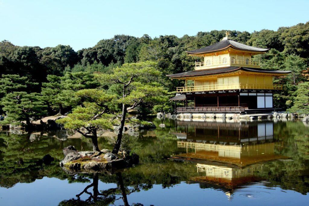 Serene view of the Golden Pavilion reflecting in the water at Kinkaku-ji in Kyoto, Japan.